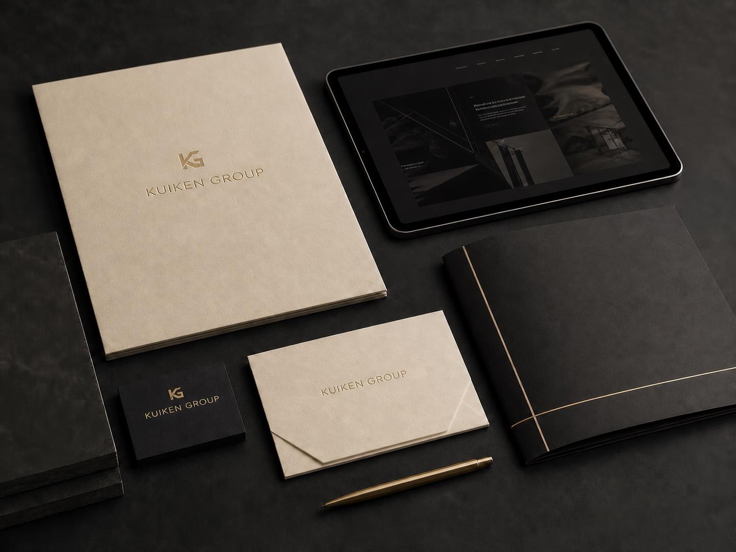 Kuiken Group identity materials with gold-foiled KG marks, stationery, and a tablet